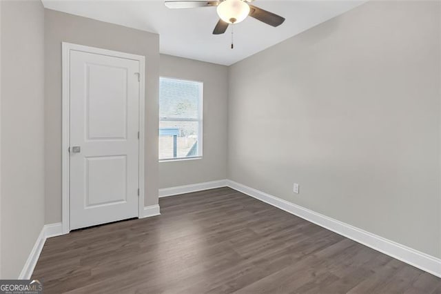 spare room featuring ceiling fan and dark hardwood / wood-style floors