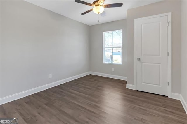 unfurnished room with ceiling fan and dark wood-type flooring