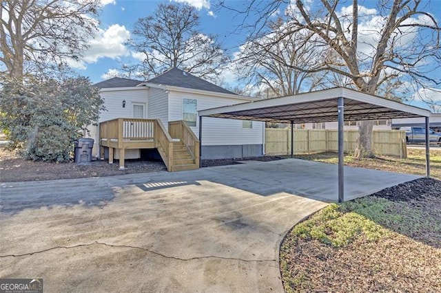 view of front of home with a deck and a carport