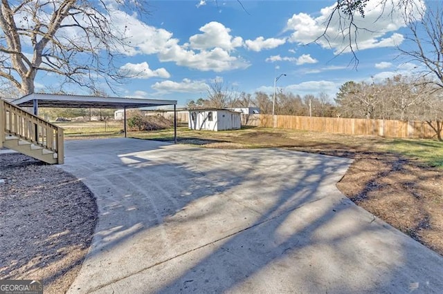 exterior space with a storage unit and a carport