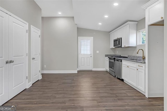 kitchen with white cabinets, light stone countertops, sink, and appliances with stainless steel finishes