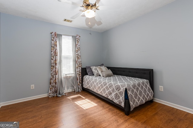 bedroom with ceiling fan and hardwood / wood-style floors