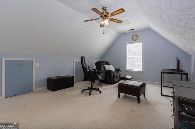 carpeted office with a textured ceiling, ceiling fan, and lofted ceiling