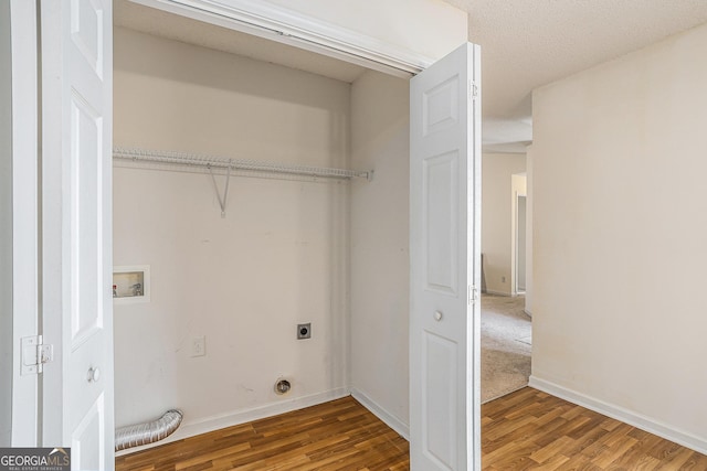 laundry area featuring hookup for an electric dryer, wood-type flooring, a textured ceiling, and hookup for a washing machine