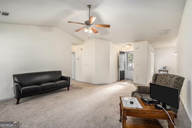 sitting room featuring light carpet, vaulted ceiling, and ceiling fan