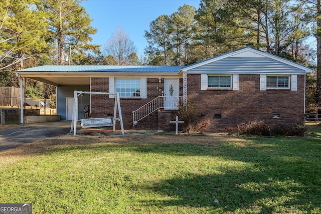 view of front facade with a front lawn and a carport