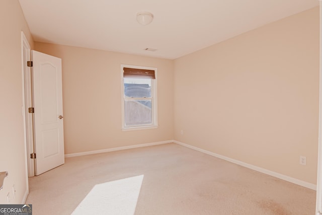 unfurnished room with light carpet