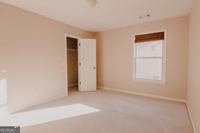 unfurnished bedroom featuring light carpet