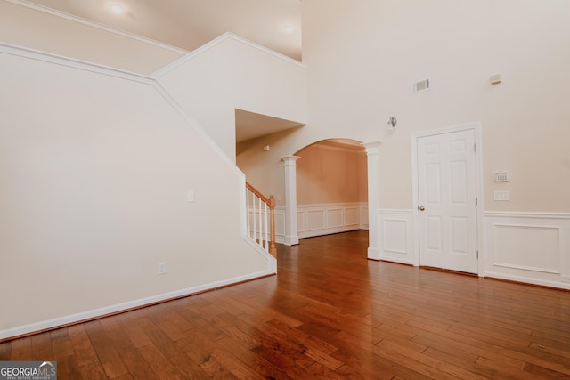 interior space featuring wood-type flooring and ornate columns