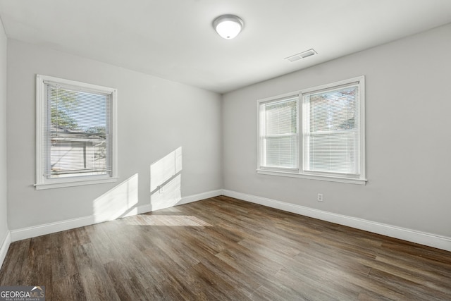 spare room featuring dark hardwood / wood-style flooring