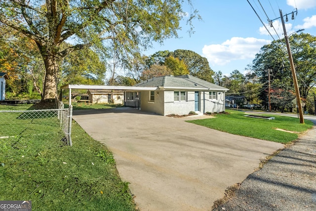 view of front of property with a front lawn and a carport