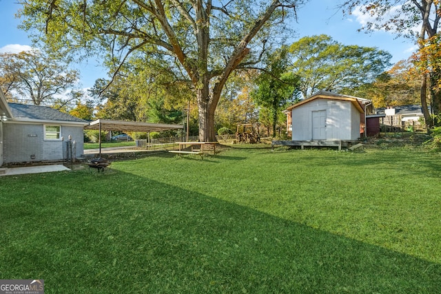 view of yard with a shed and a carport