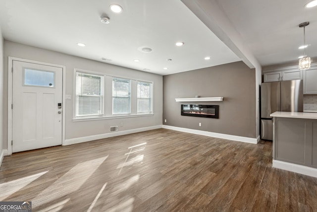 unfurnished living room featuring hardwood / wood-style floors