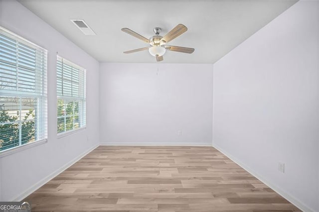 empty room featuring ceiling fan and light wood-type flooring