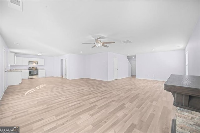 unfurnished living room featuring light wood-type flooring and ceiling fan