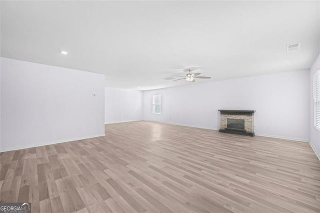 unfurnished living room with light hardwood / wood-style flooring and ceiling fan