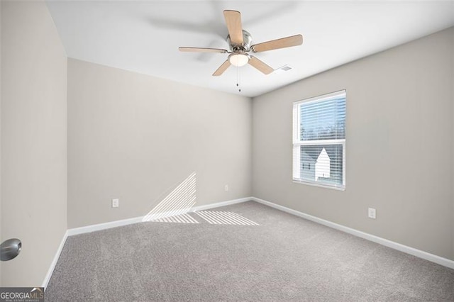 spare room featuring carpet flooring and ceiling fan