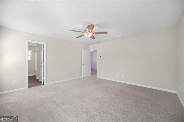 unfurnished room featuring ceiling fan and carpet floors