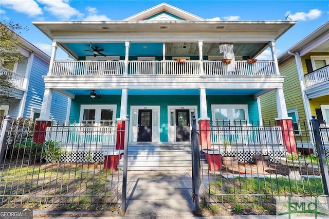 view of front of house featuring ceiling fan, a balcony, and covered porch