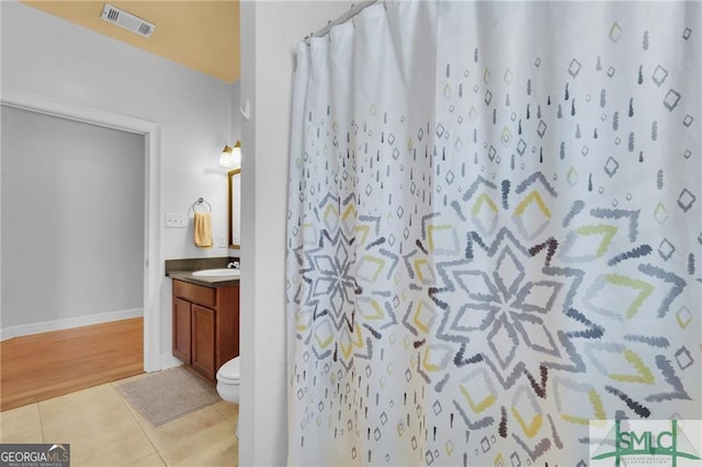 bathroom with toilet, tile patterned flooring, vanity, and a shower with shower curtain