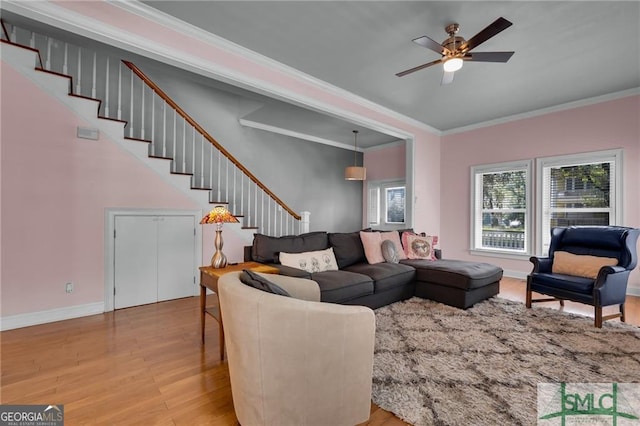 living room with hardwood / wood-style floors, ceiling fan, and ornamental molding