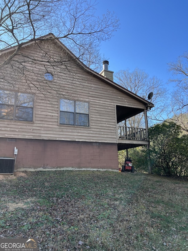 view of home's exterior featuring a yard and central AC