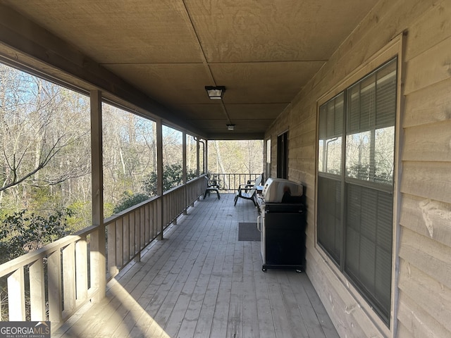 unfurnished sunroom with wood ceiling