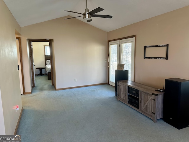 unfurnished living room featuring ceiling fan, light colored carpet, and vaulted ceiling