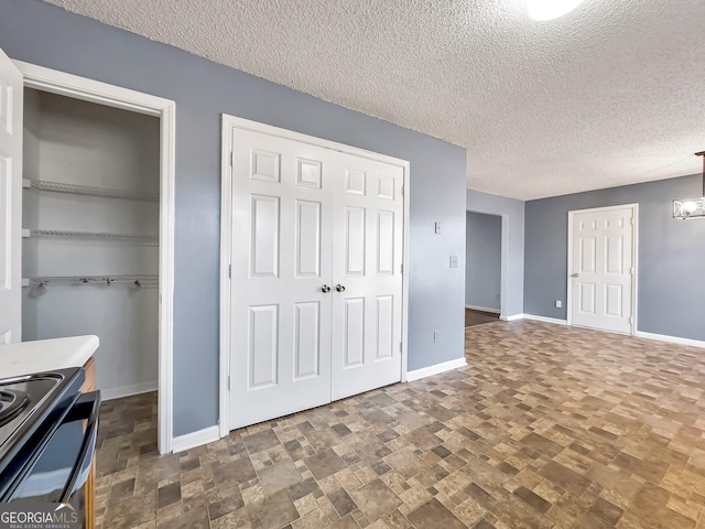 unfurnished bedroom with two closets and a textured ceiling