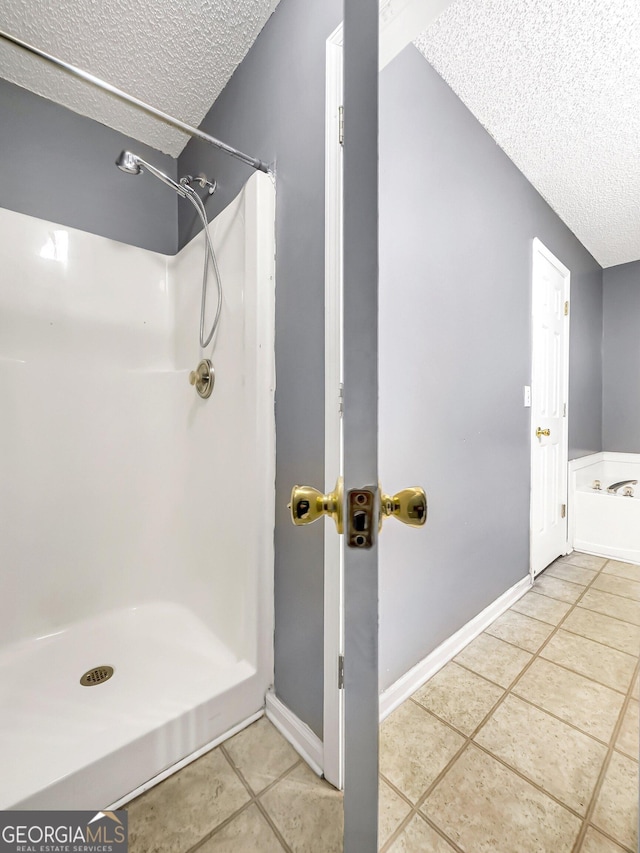 bathroom featuring tile patterned floors, a textured ceiling, and walk in shower