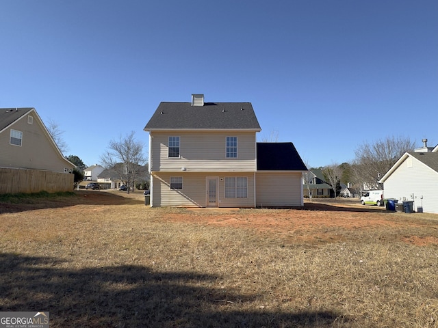 back of property featuring a yard