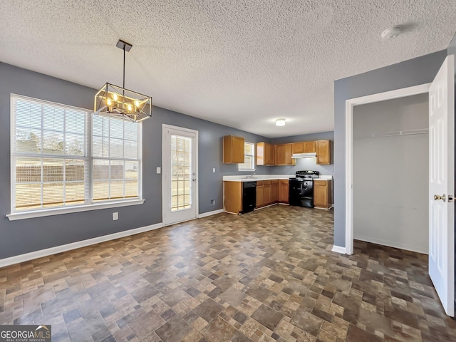 kitchen with an inviting chandelier, hanging light fixtures, a wealth of natural light, and black appliances