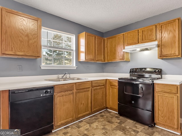 kitchen featuring sink, black appliances, and a textured ceiling