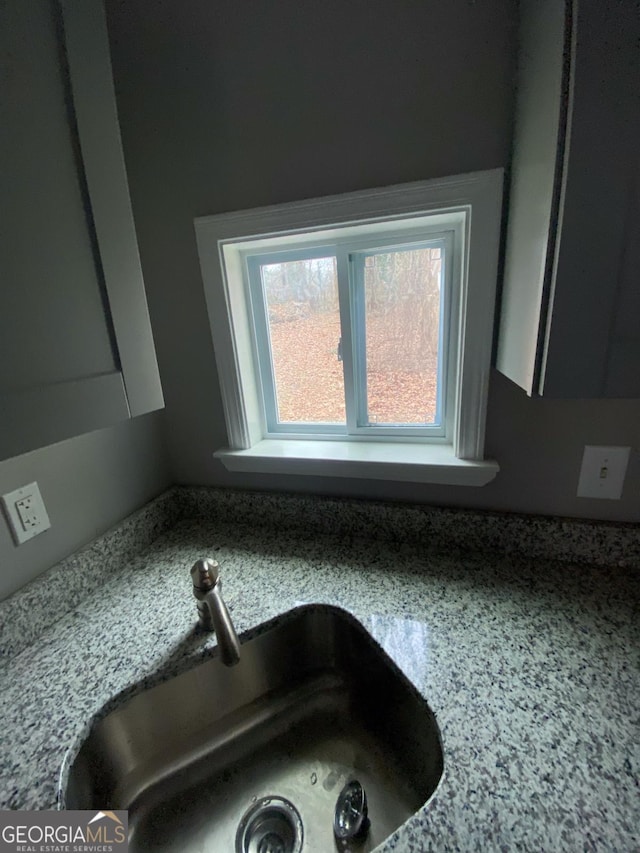 interior details with light stone counters and sink