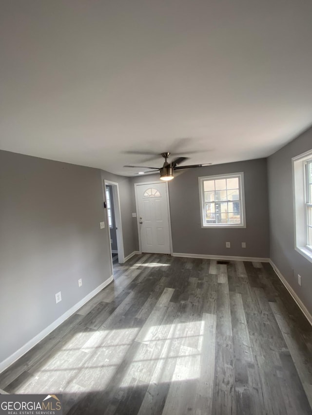 spare room featuring ceiling fan and dark hardwood / wood-style floors