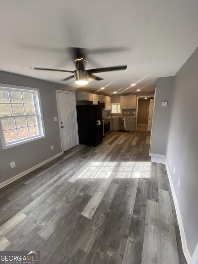 unfurnished living room with ceiling fan and dark hardwood / wood-style floors