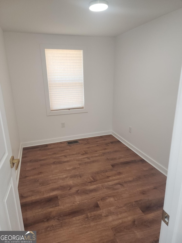 spare room featuring dark hardwood / wood-style floors