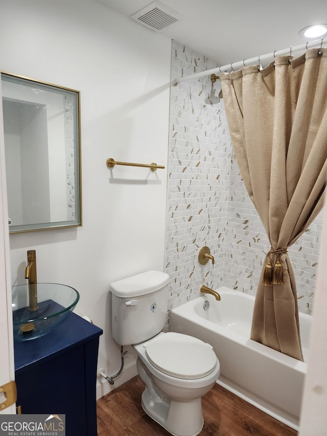 full bathroom with shower / bath combo, toilet, vanity, and wood-type flooring