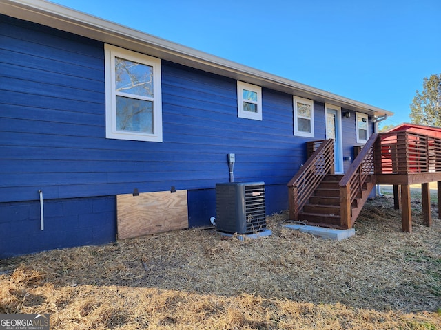 back of property featuring a wooden deck and central air condition unit