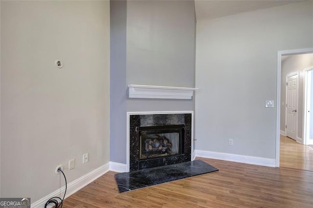 unfurnished living room with hardwood / wood-style floors and a fireplace