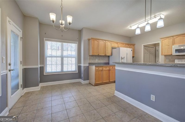 kitchen with pendant lighting, a chandelier, white appliances, and tasteful backsplash