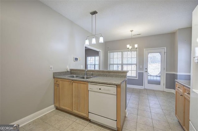 kitchen featuring kitchen peninsula, white dishwasher, hanging light fixtures, and sink