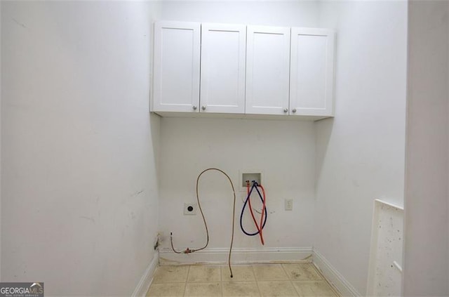 laundry area with electric dryer hookup, hookup for a washing machine, and cabinets