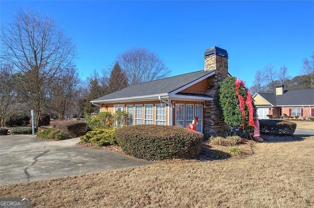 view of side of home with a yard