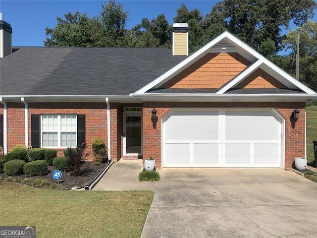 view of front of property featuring a garage and a front lawn