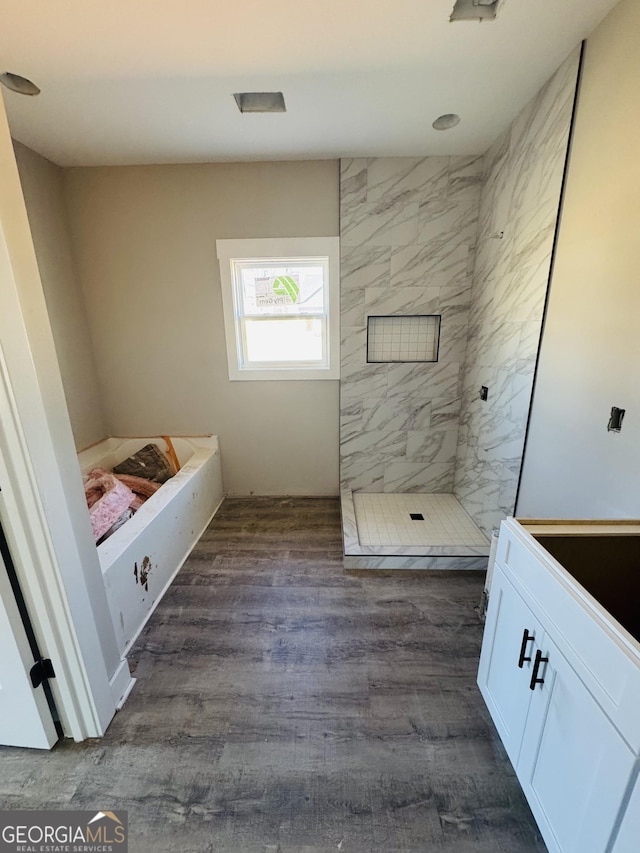 full bathroom featuring walk in shower and wood finished floors