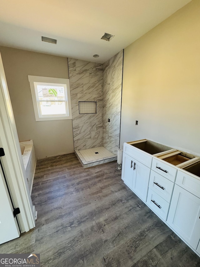 full bath with walk in shower and wood finished floors