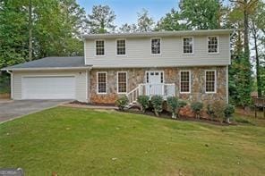 view of front of property with a garage and a front lawn