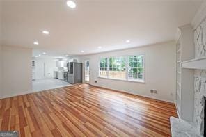 unfurnished living room with light hardwood / wood-style flooring