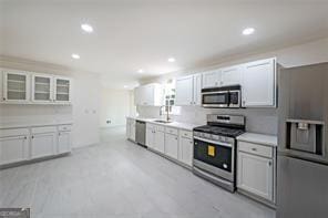 kitchen with white cabinets, stainless steel appliances, and sink